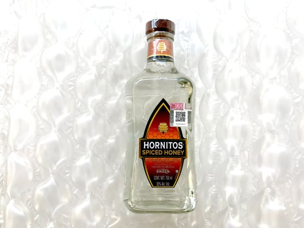 tequila wrapped for traveling in bubble wrap